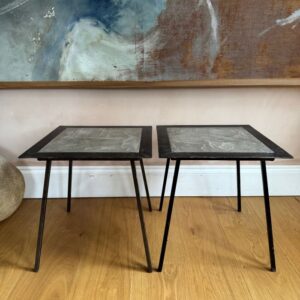 A pair of French 1960’s polished iron and concrete side tables signed Pierre Machefer